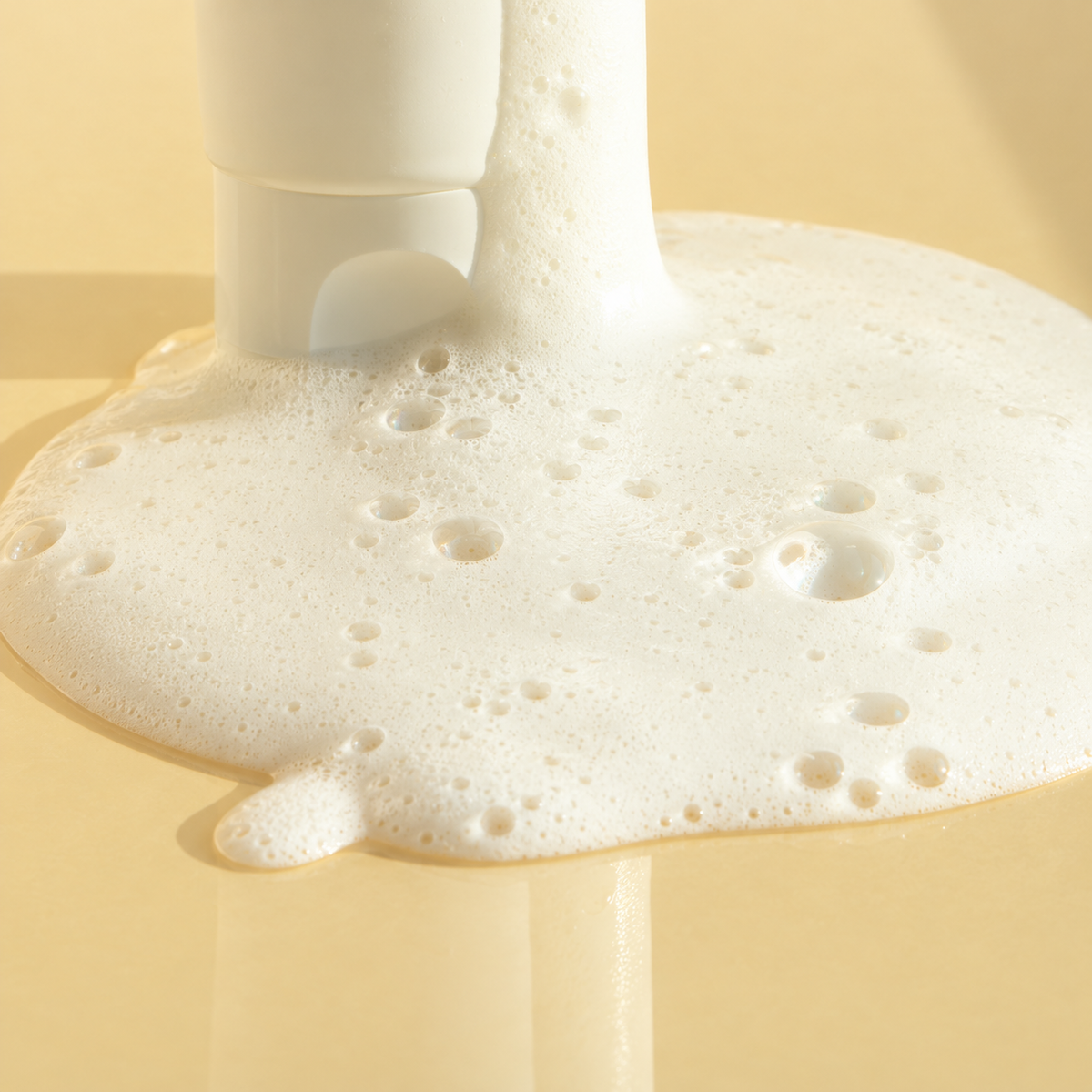 Close-up of the creamy white lather and fine bubbles of FAU Skin Solution SOS Foam Cleanser.