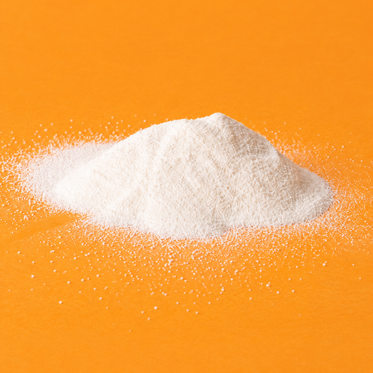 Close-up of FAU enzyme cleansing powder showing its fine white texture on an orange background.